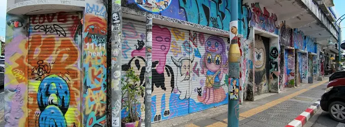 Colourful graffiti murals covering a row of shop shutters
